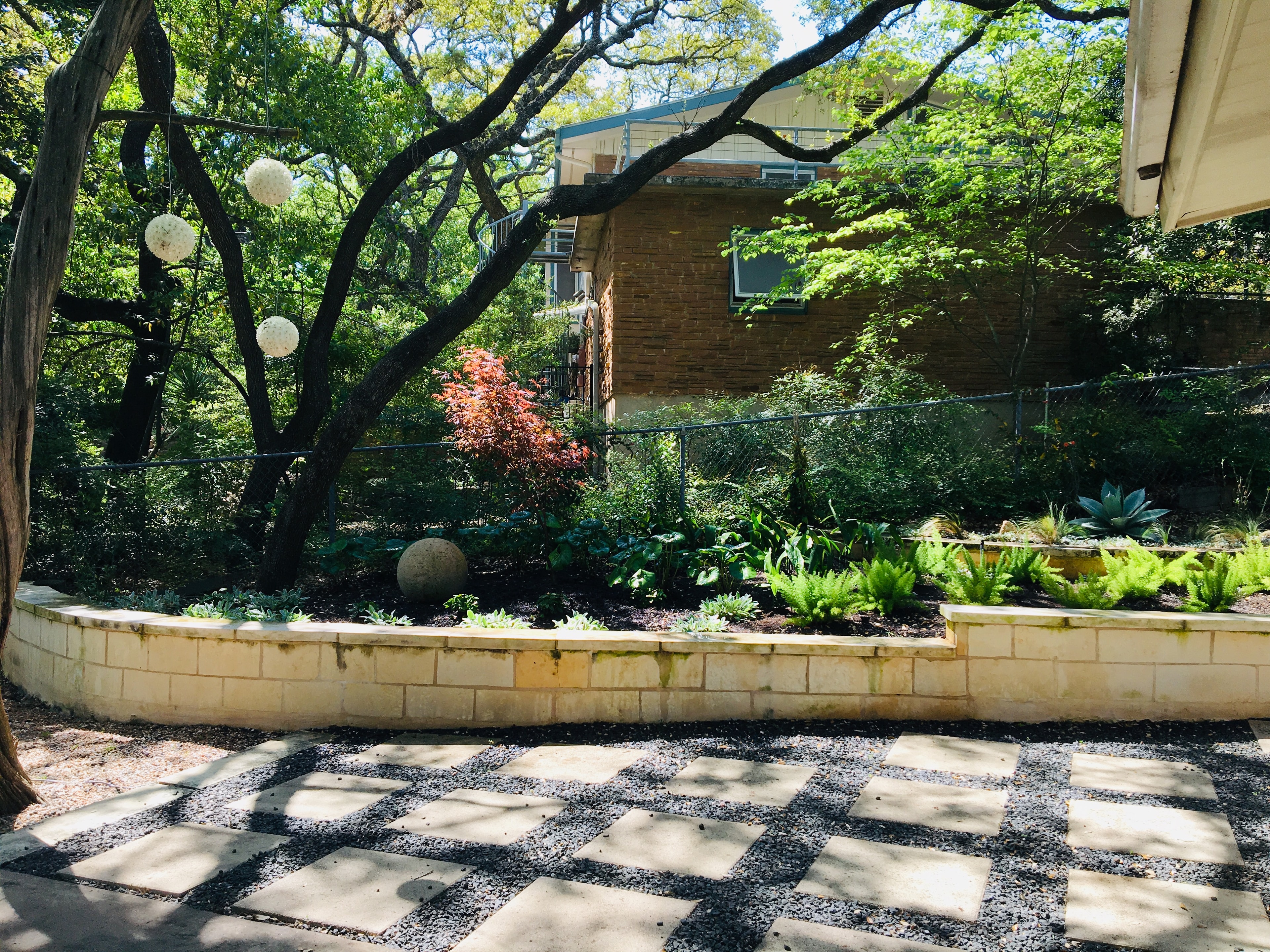 Lush residential front yard with mature oak trees