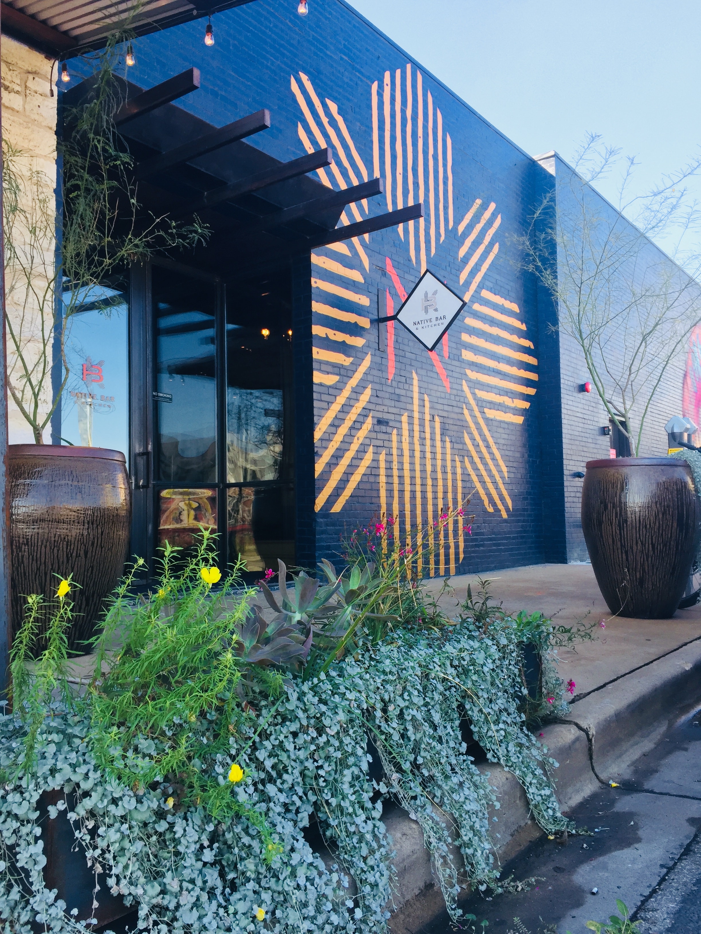 Native Bar and Kitchen storefront with bold mural and native plant design