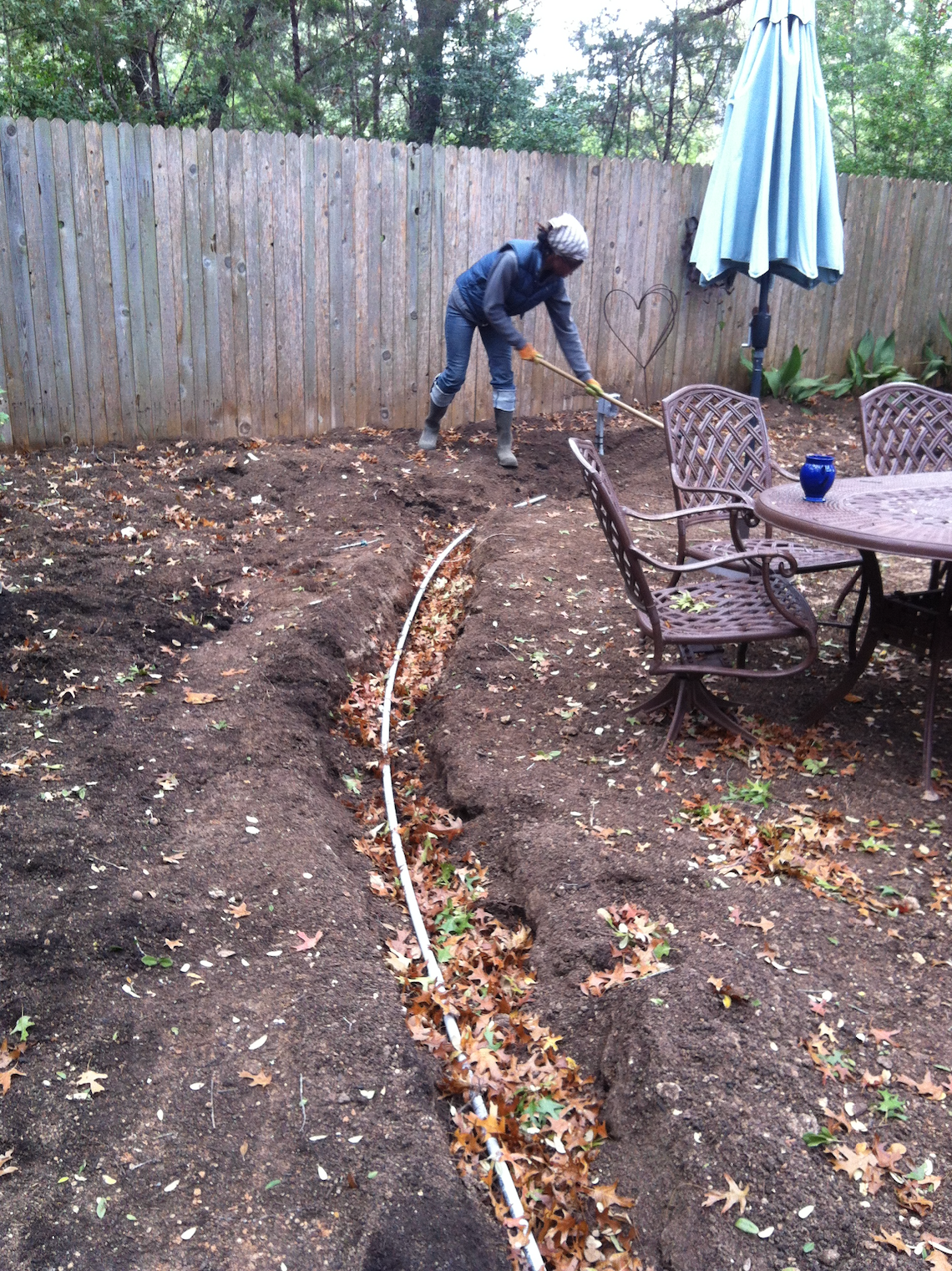 512 Phoenix crew member installing irrigation in a backyard