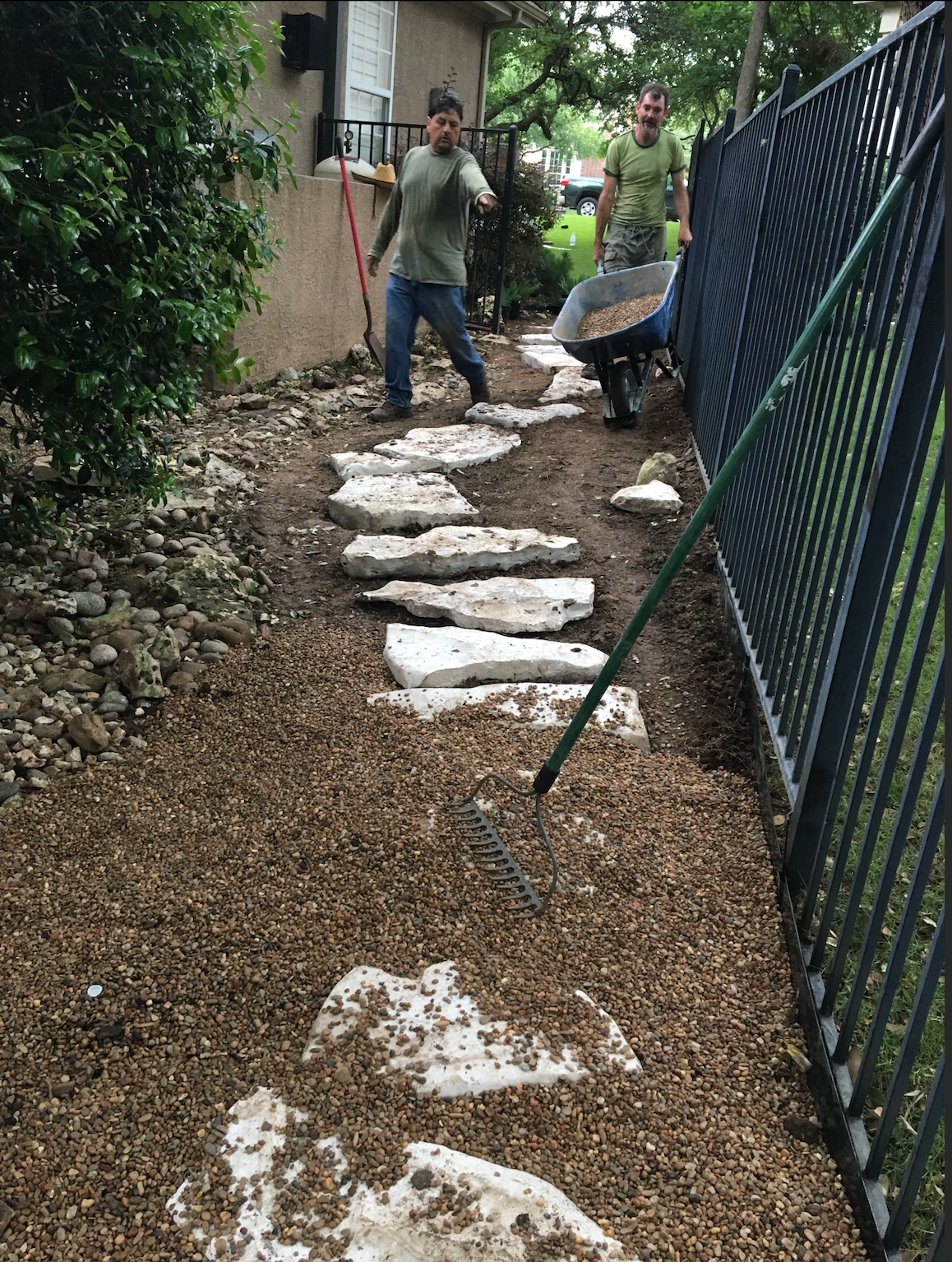 512 Phoenix crew laying a flagstone pathway with wheelbarrow